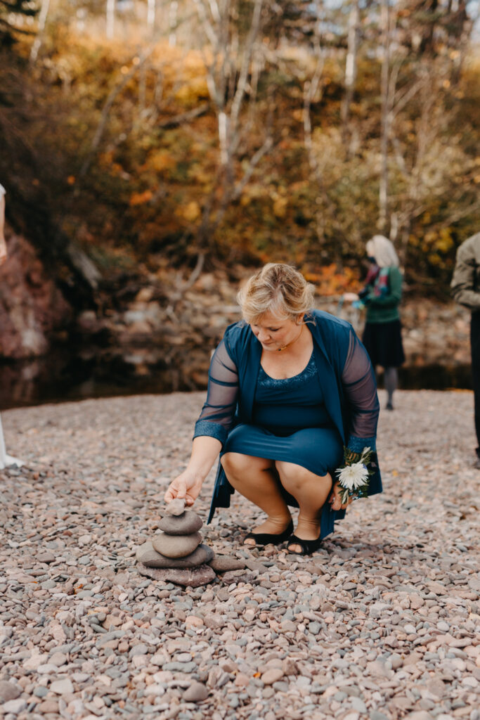 elopement rock stacking ceremony with mother placing her stone