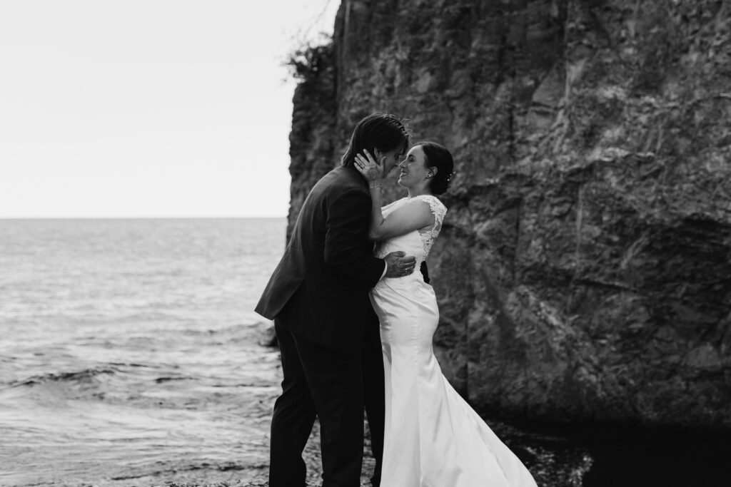 black and white first kiss portrait between bride and groom 