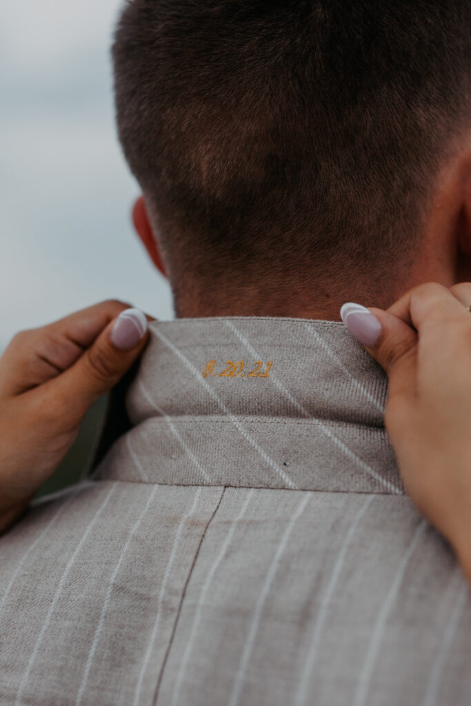 groom suit detail of embroidered wedding date 