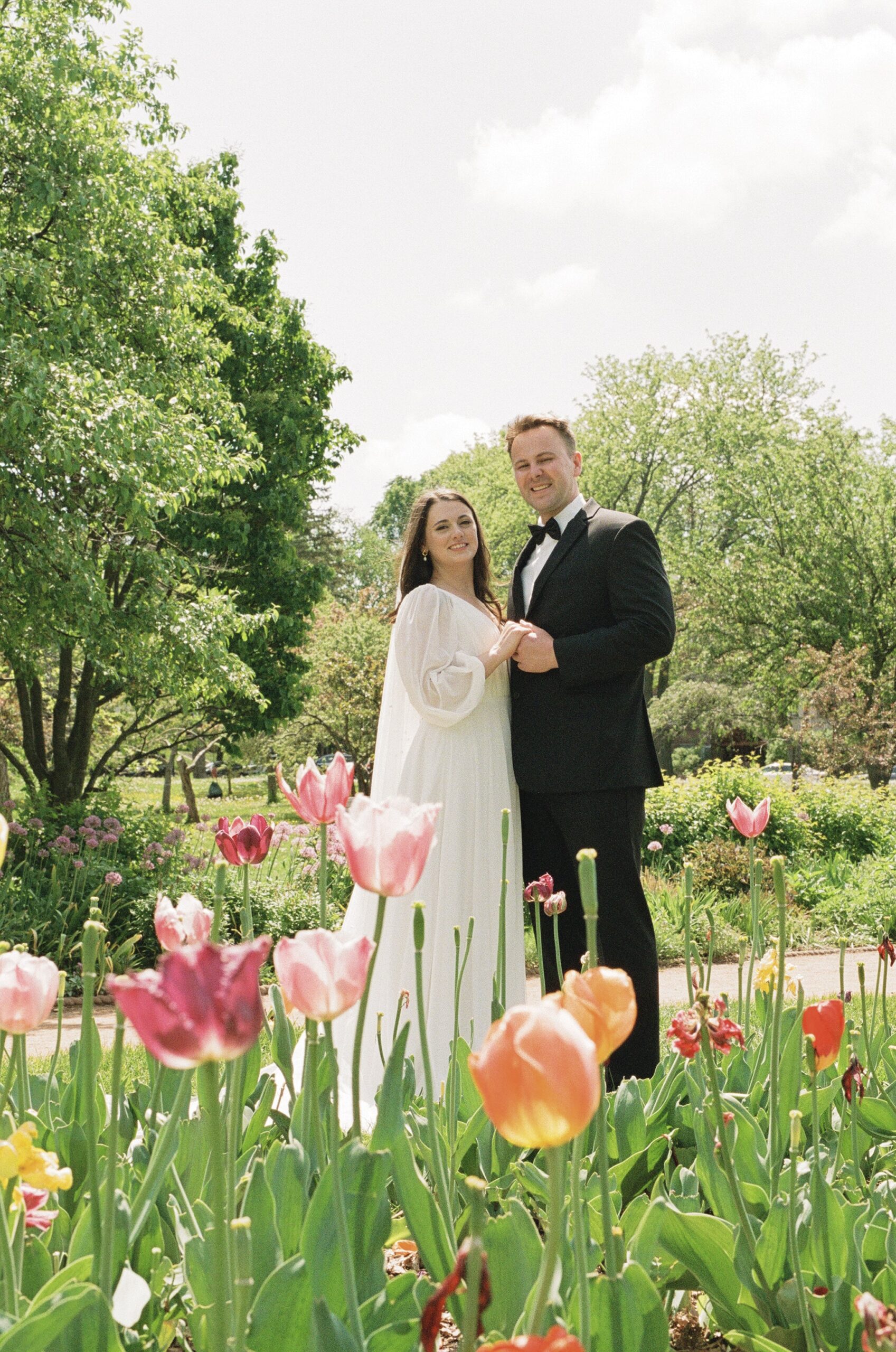 bride and groom film portrait in a tulip garden