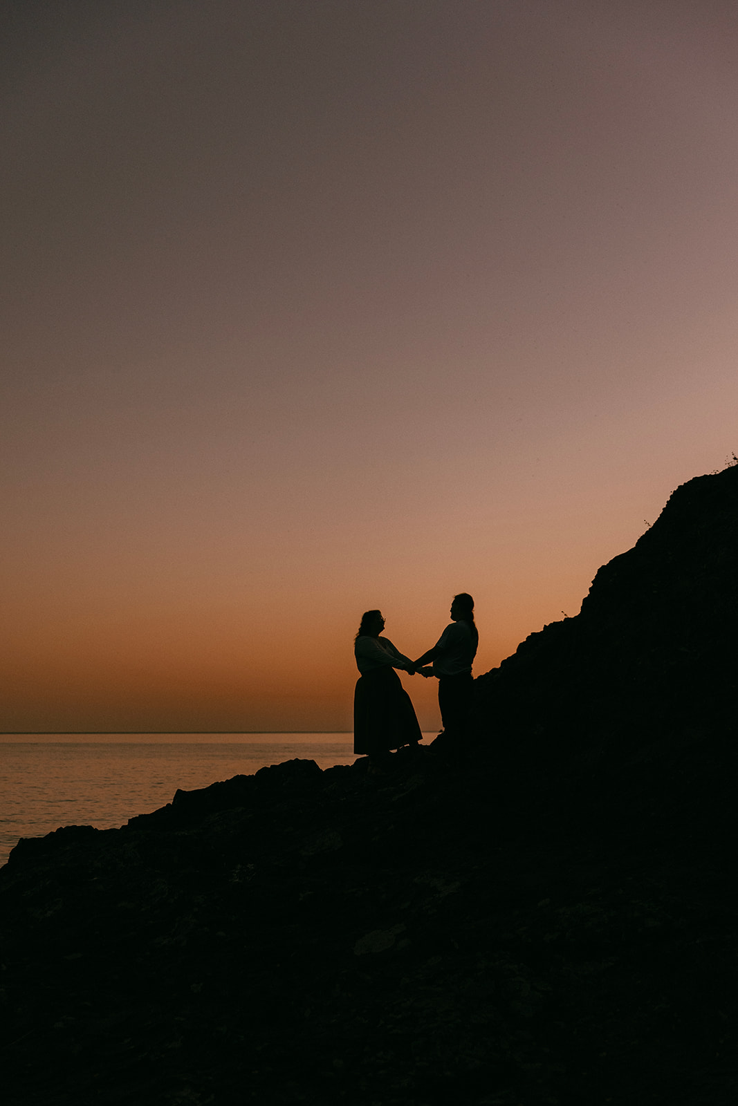 dusk silhouette of couple holding hands at tettegouche state park