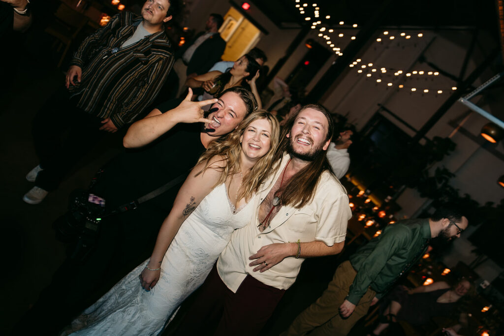 portrait of brianna kirk with clients on the energetic dance floor